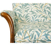 close up of chair arm and seat in teal leafy fabric
