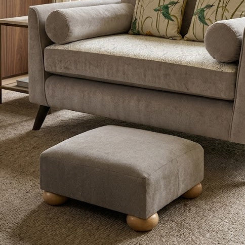 Gray sofa with patterned cushions in a living room setting