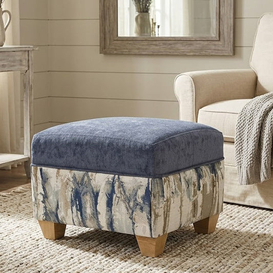 Blue ottoman with patterned base in a living room setting