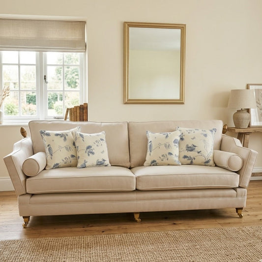 Beige sofa with floral cushions in a living room setting.