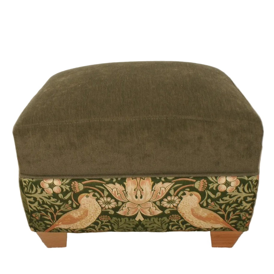 Green ottoman with floral and bird pattern on a plain background