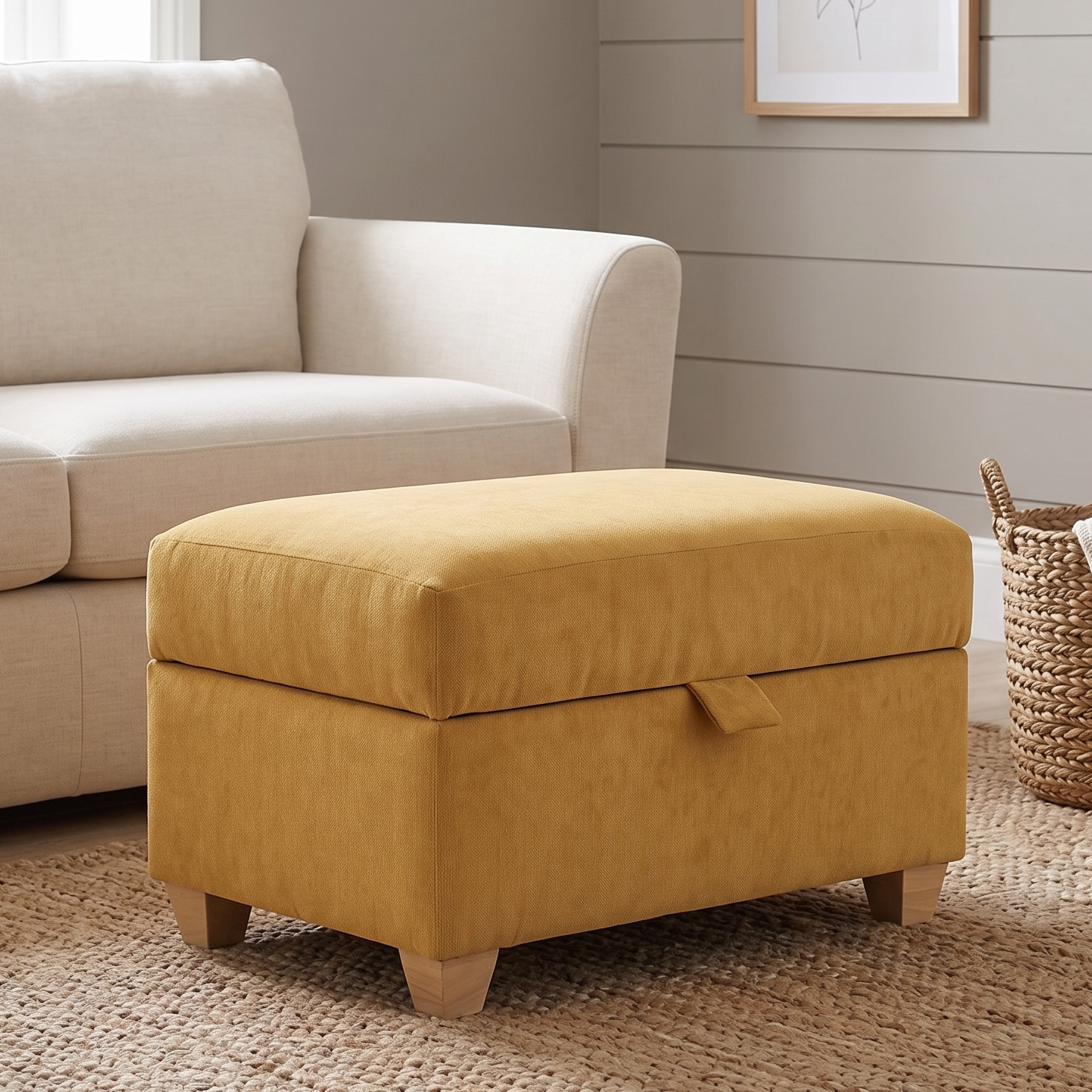 Yellow ottoman in a living room setting with a beige sofa and wooden side table.