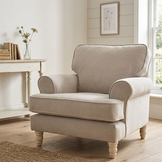 Beige armchair in a room with a fireplace and window